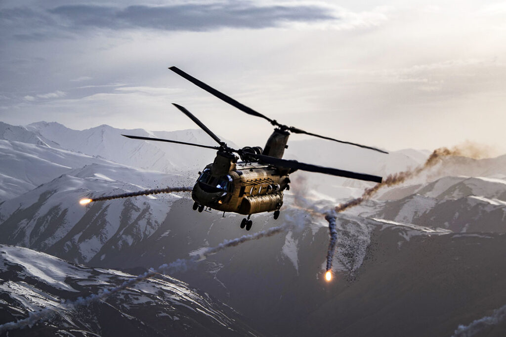 A CH-47F Chinook helicopter releases flares during a joint Army and Air Force training exercise over Bagram Airfield, Afghanistan, March 26, 2018. [USAF/TSgt Gregory Brook]