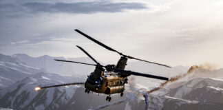 A CH-47F Chinook helicopter releases flares during a joint Army and Air Force training exercise over Bagram Airfield, Afghanistan, March 26, 2018. [USAF/TSgt Gregory Brook]