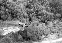 A ‘Ranch Hand’ UC-123 deploying a defoliant (either Agent White or more likely Agent Orange) to clear a roadside in central South Vietnam in 1966. [USAF]