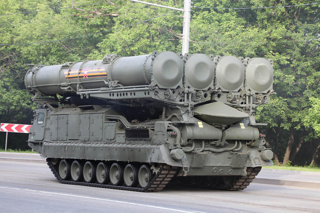 A 9A83M transporter, erector, launcher, and radar (TELAR) of the S-300V4 system. The continuous wave illumination radar for the track-via-missile (TVM) guidance system can be seen folded over the rear deck, under the missile containers. [RecoMonkey]