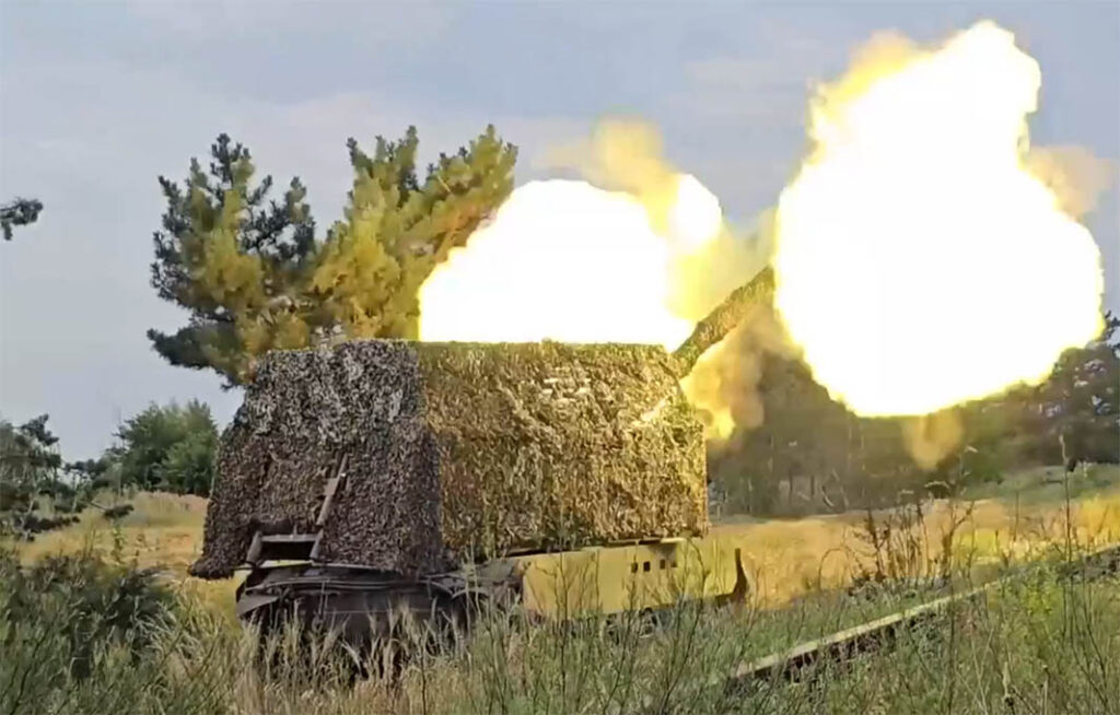 A screengrab from Russian MoD footage showing a Msta-S SPH equipped with part of an additional protection kit, which includes an anti-drone cage around the turret, supplemented with camouflage netting. (Russian MoD)