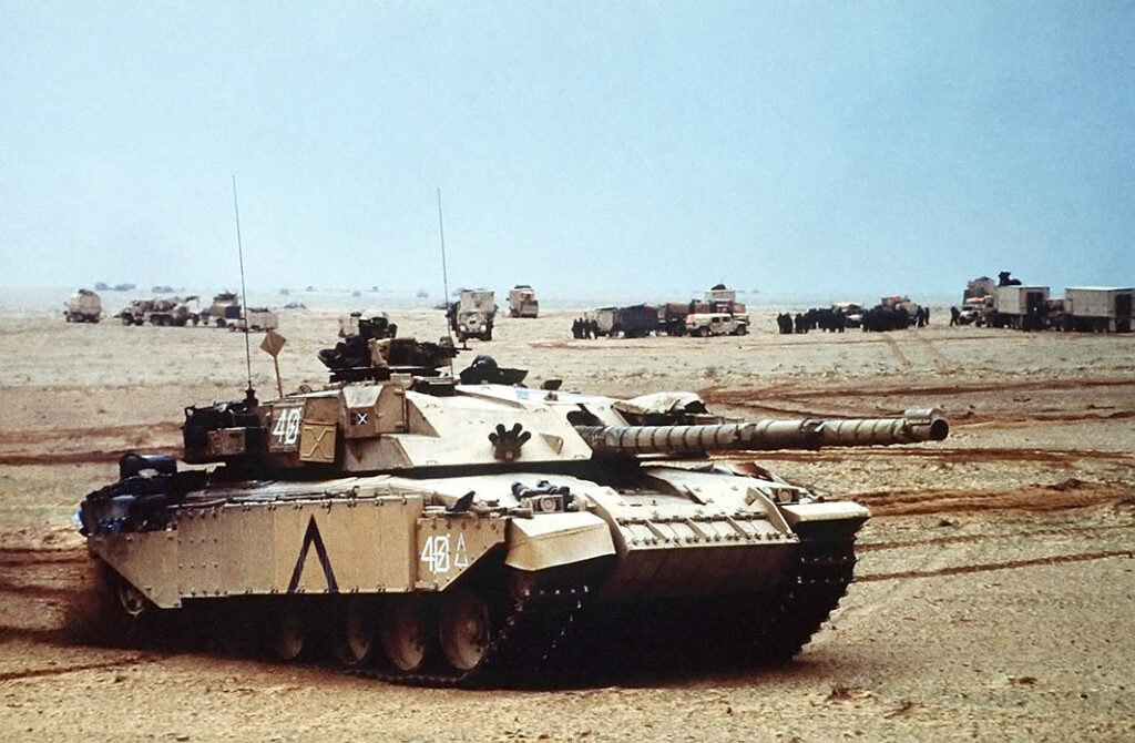 A Challenger 1 of the Royal Scots Dragoon Guards moving through the desert. The tanks were significantly enabled by massed artillery, and coalition forces were under strict orders not to advance without artillery preparation. [US DoD/PHC Holmes, via Wikimedia Commons]