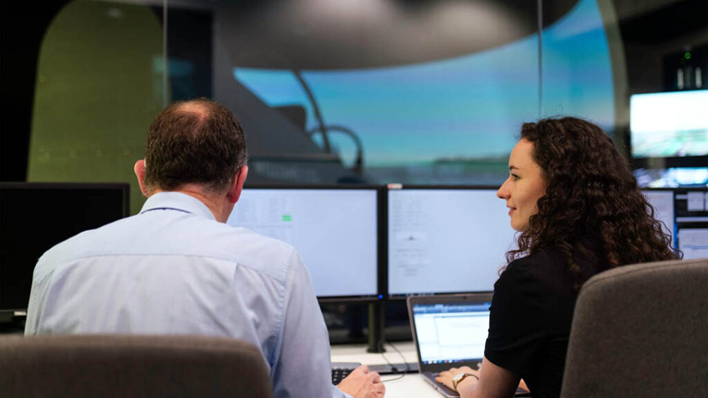 Two engineers control a flight simulator. [Picture © Harry Parvin via Canva.com]