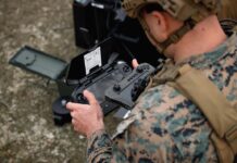 SUAVs are controlled via handheld devices, tablets and laptops. Here a USMC rifleman operates a Skydio X2D. [USMC/Cpl Joshua Barker]