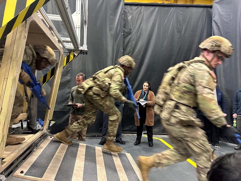 Soldiers from the 1st Infantry Division participate in a January 2024 Soldier Touchpoint at the Detroit Arsenal, reviewing plans and interacting with mock-ups of potential future designs of the XM30, providing insights on what soldiers liked or did not like about the possible designs. [US Army]