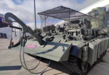 An upgraded BREM-1M armoured recovery vehicle, featuring a new explosive reactive armour (ERA) layout, anti-drone protection, and electronic warfare jammers. Note the towing coupler attached to the dozer blade, which allows the crew to recover damaged vehicles without leaving their own vehicle. [Alexey Tarasov]