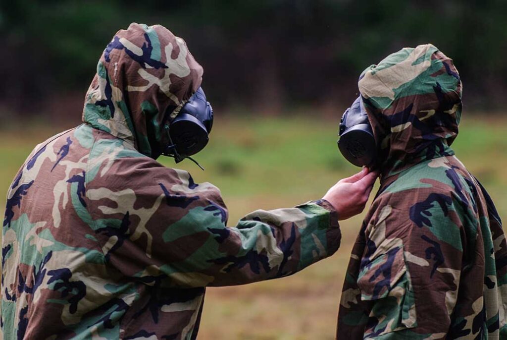 Two US Army soldiers wearing JSLIST suits using carbon sphere technology. (US Army/Spc Sean Harding)
