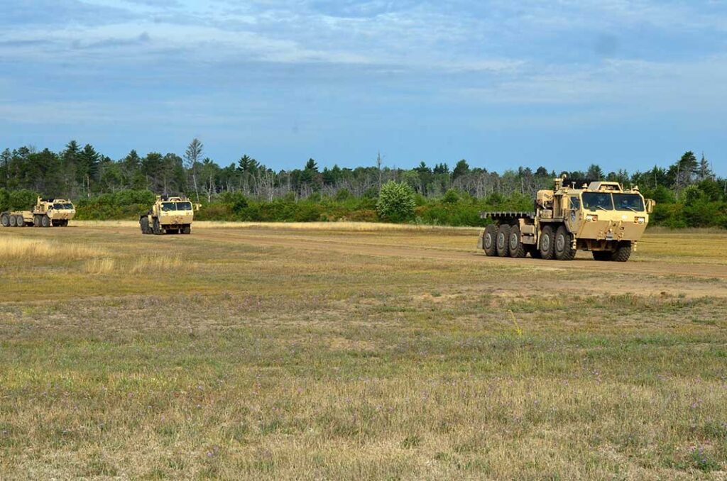 A convoy of optionally-manned trucks in Autonomous Leader-Follower mode navigate a roadway on Camp Grayling, Michigan, on 28 August 2019. [US Army]