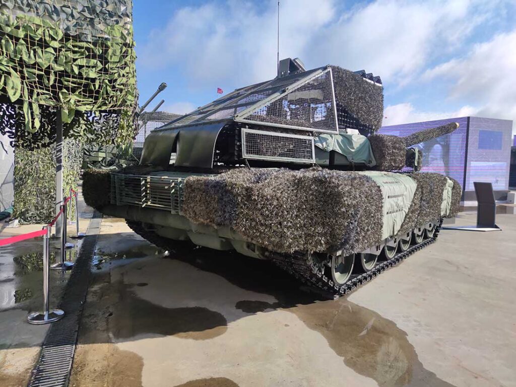 A T-80BVM tank featuring an array of anti-drone protection measures, including passive barriers, ERA, and electronic warfare jammers. [Alexey Tarasov]